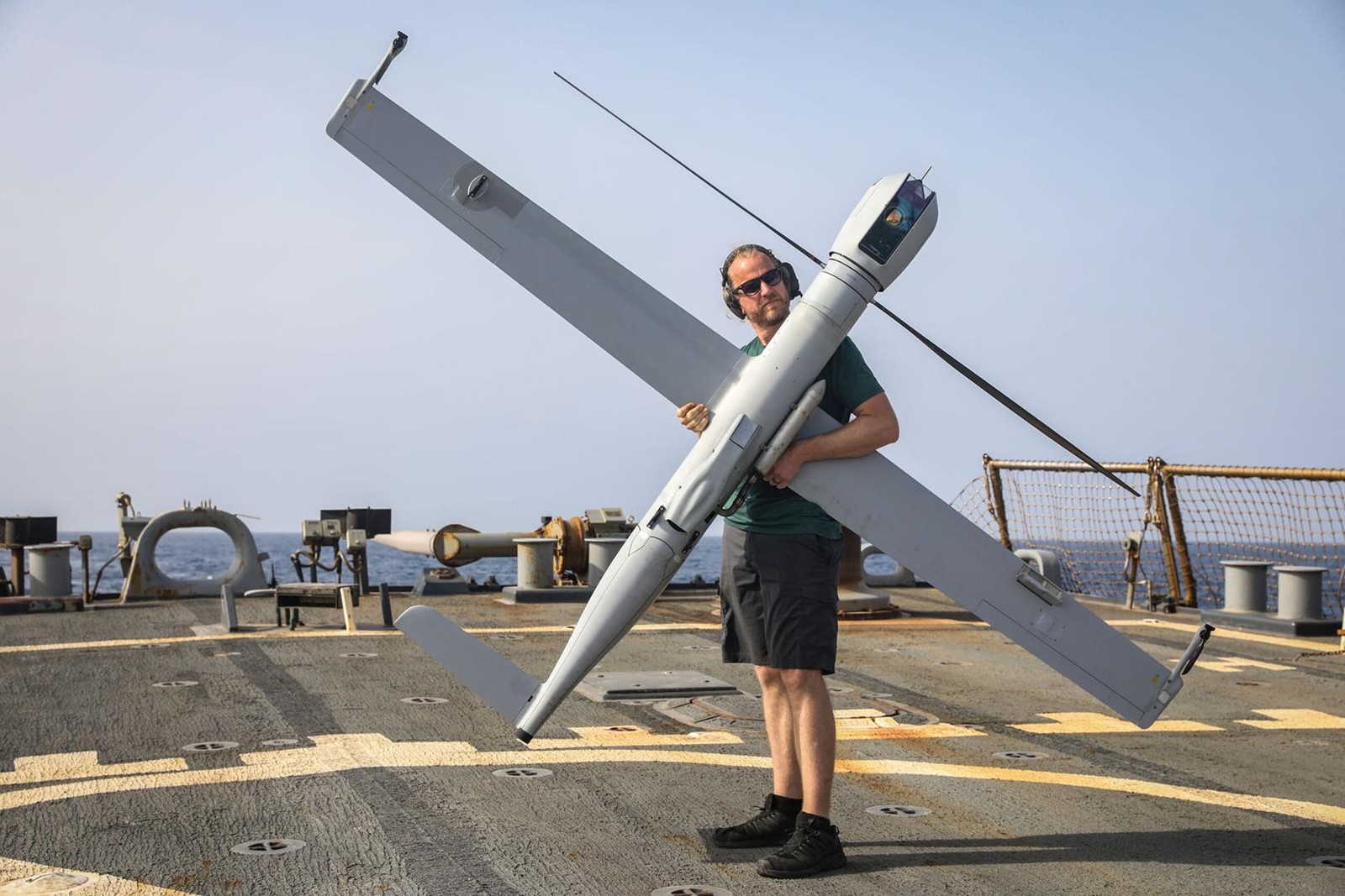 GULF OF OMAN (July 23, 2023) Michael Uridil places a Flexrotor long-range robotic aircraft on the flight deck of the guided missile destroyer USS McFaul (DDG 74) during flight operations, July 23, 2023. McFaul is deployed to the U.S. 5th Fleet area of operations to help ensure maritime security and stability in the Middle East region. (U.S. Photo by Mass Communication Specialist 2nd Class Juel Foster)
