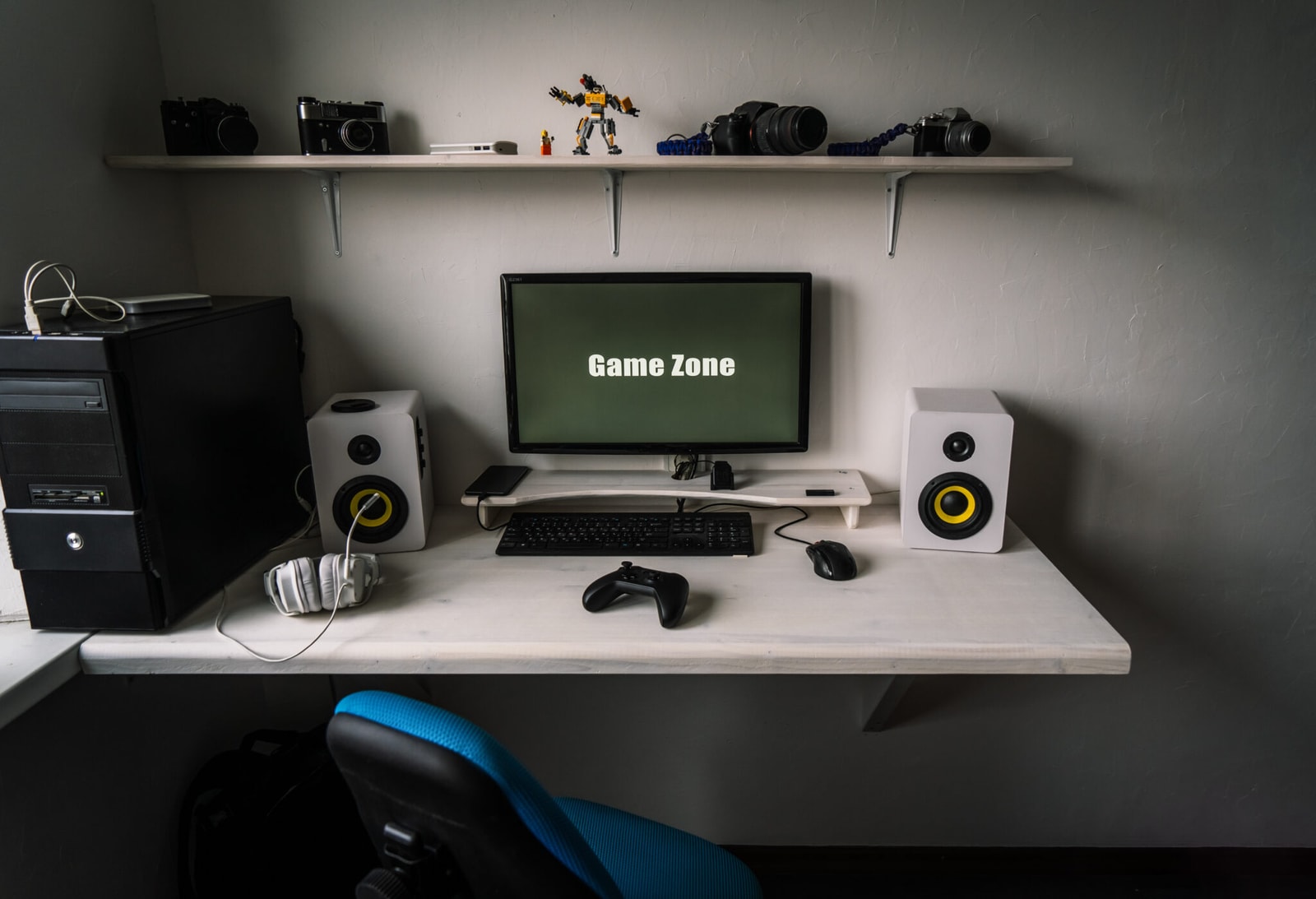 The workplace of a professional gamer with a monitor, gamepad, headphones and an armchair. Interior.
