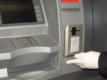 Mocowany na szczelinie bankomatu miniskaner odczytuje kod magnetyczny karty, zanim trafi ona do systemu.