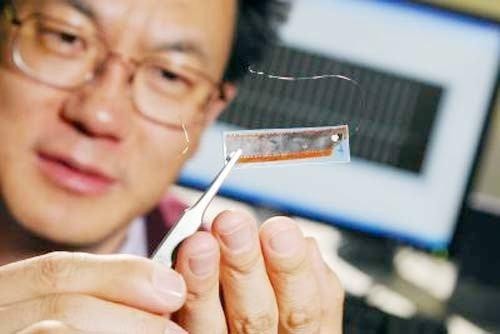 Dr Wang, trzymający nanokabel, który można będzie wpleść w ubranie człowieka