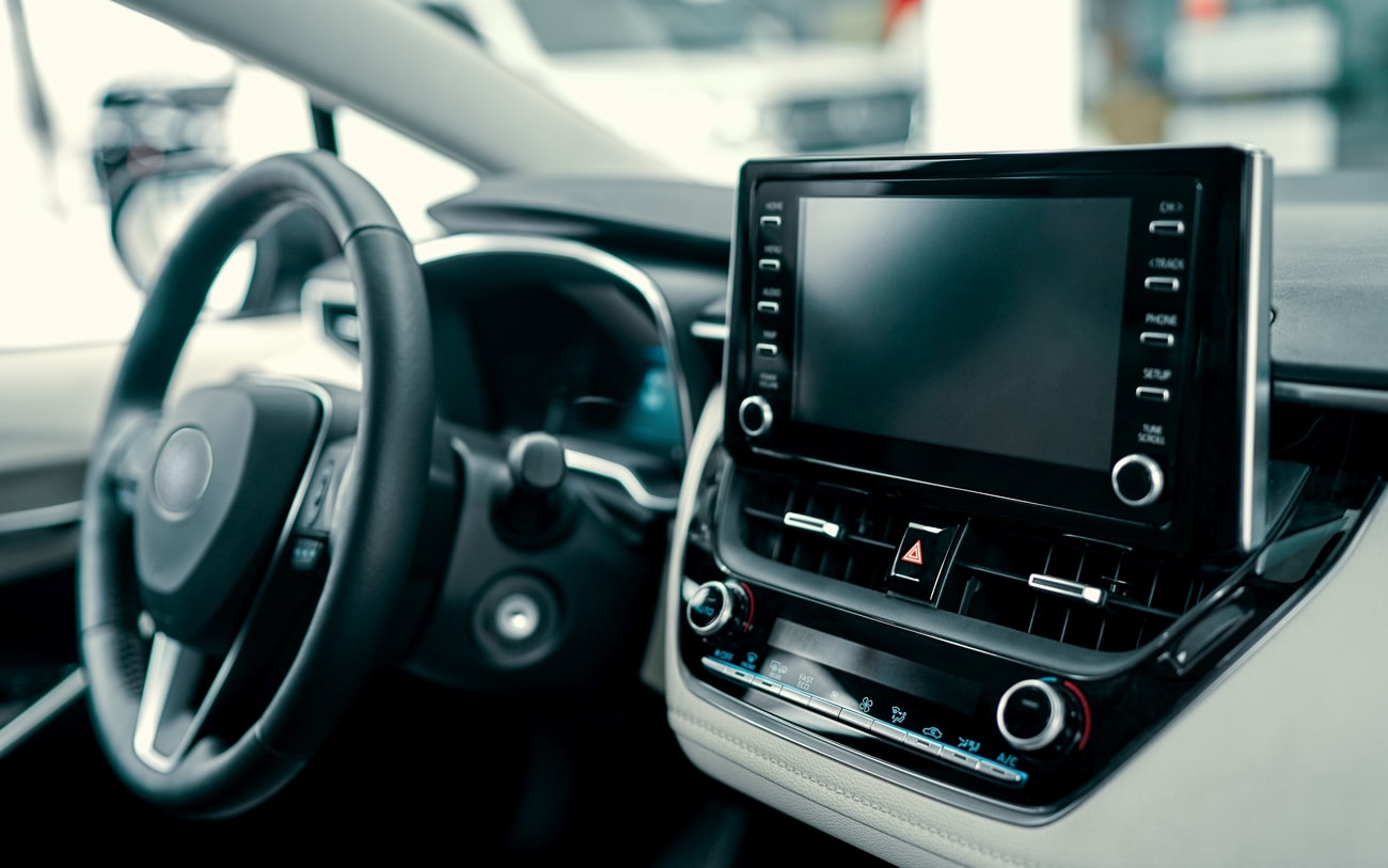 Luxury car interior. Steering wheel, shift lever and dashboard.
